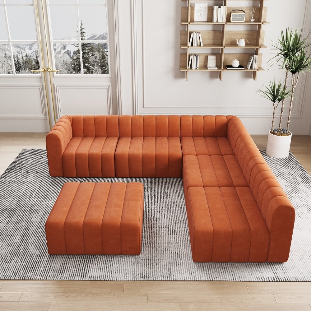 Orange sectional sofa with ottoman in a living room setting