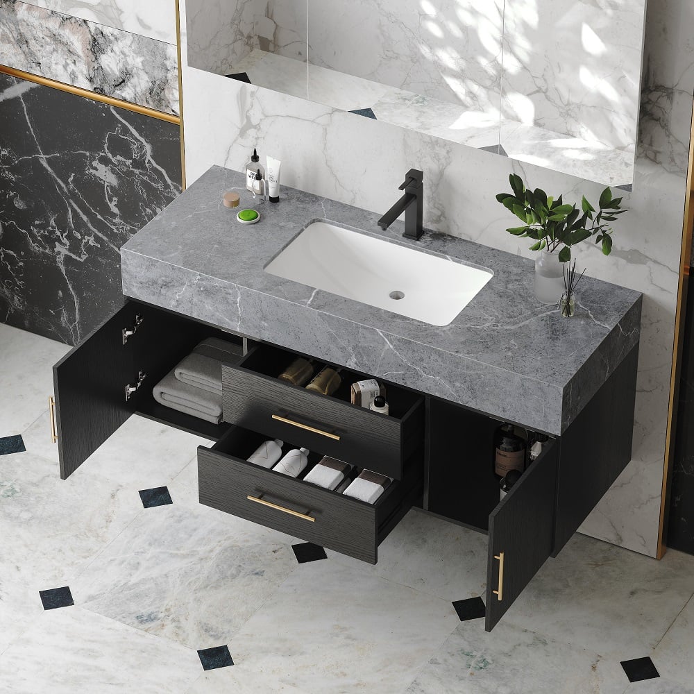Bathroom vanity with open drawers, sink, and decorative elements on a marble floor.