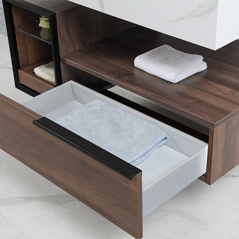 Wooden bathroom cabinet with open drawer containing folded towels.