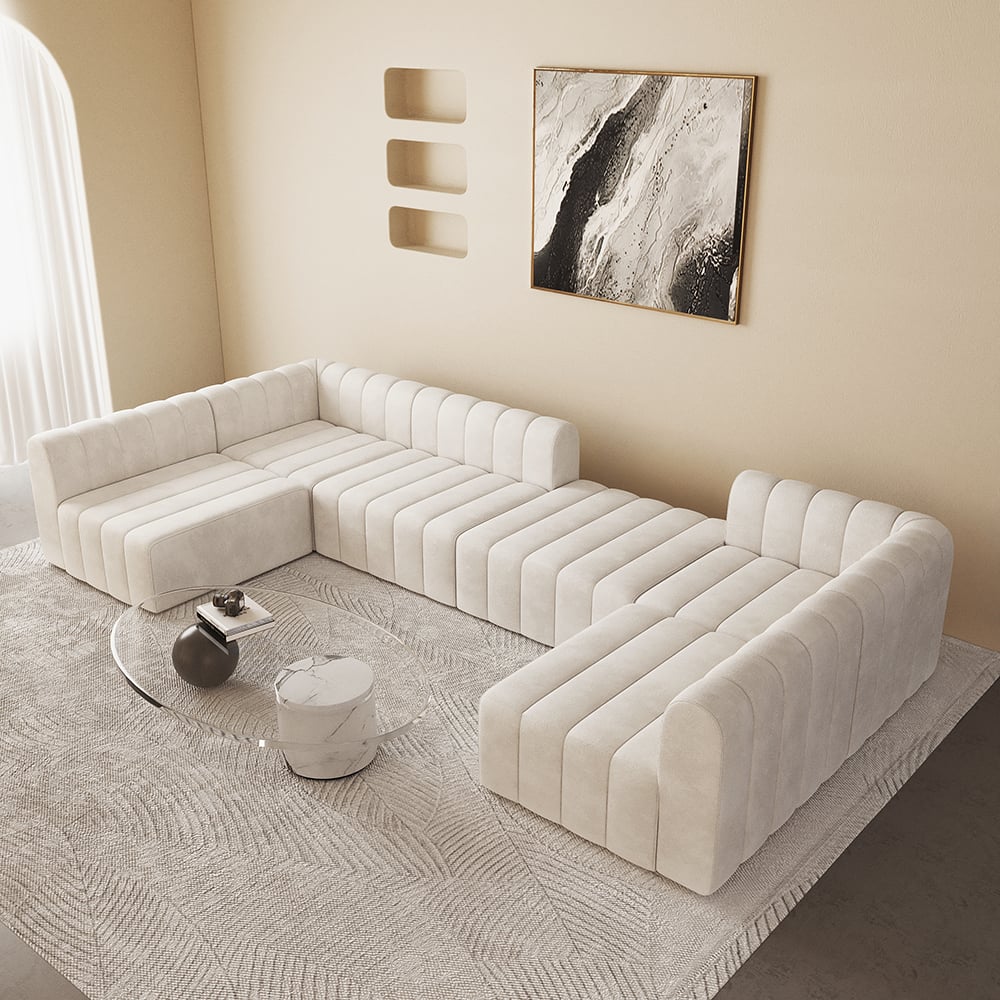 Modern off white sectional sofa in a living room setting with abstract art on the wall.