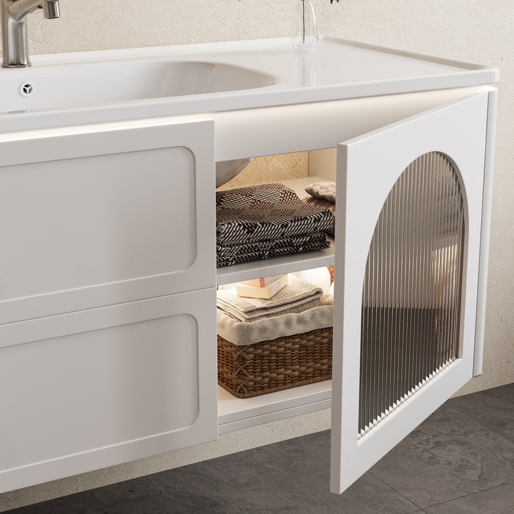 White kitchen cabinet with open door revealing storage items, including a sink.