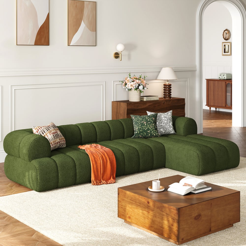 Modern living room with a green sectional sofa and wooden coffee table.