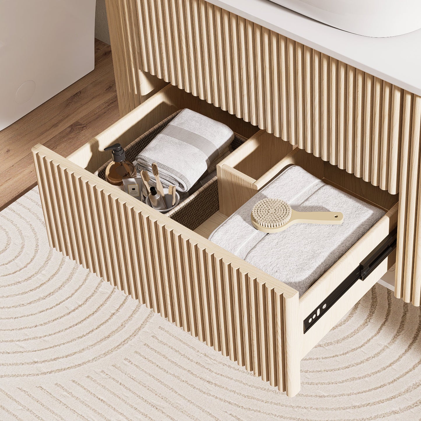 Open wooden drawer with folded towels and bathroom items on a wooden floor.