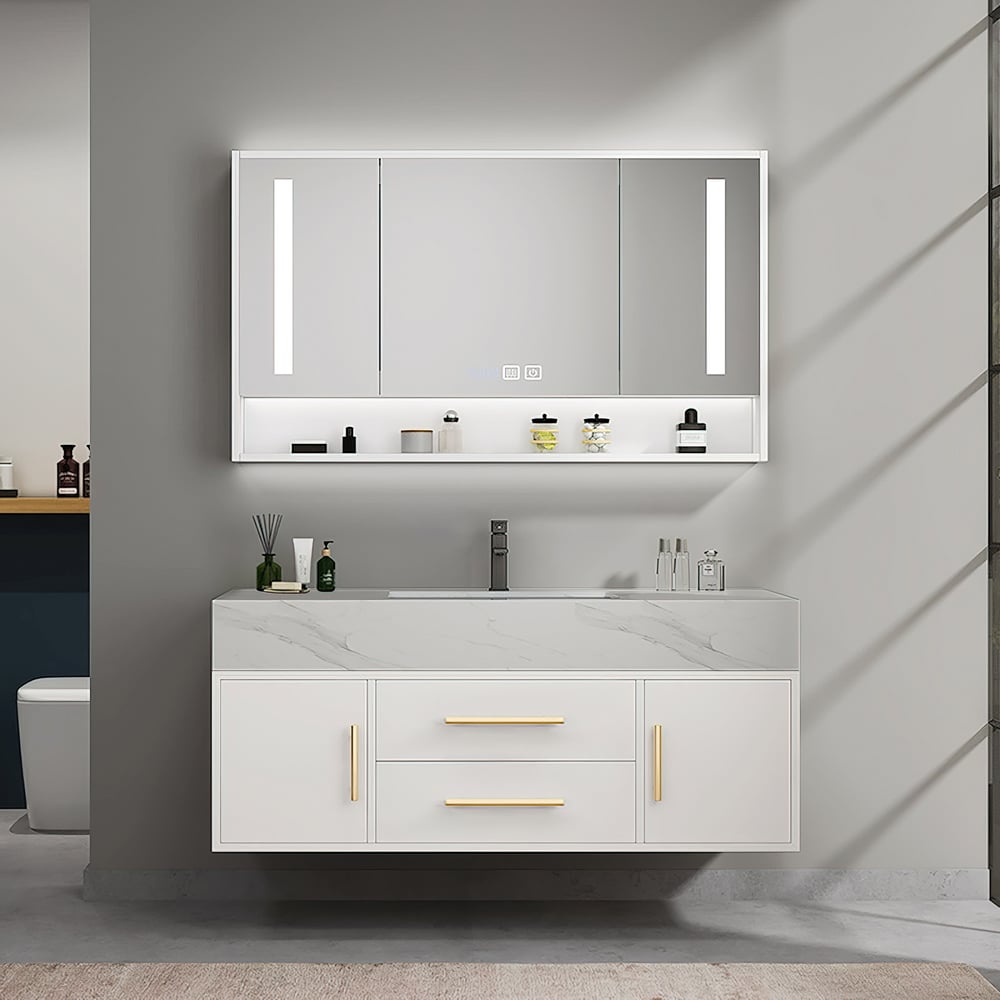 Bathroom vanity with illuminated mirror and various toiletries on a gray wall.