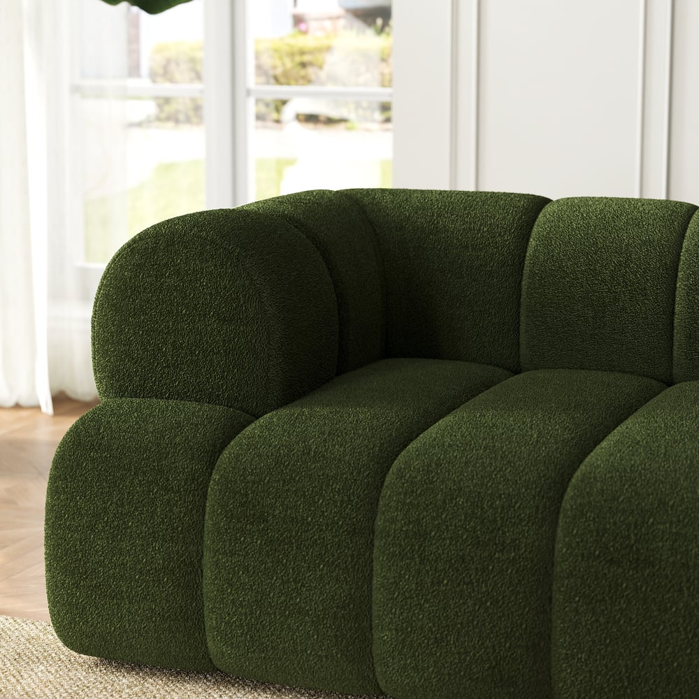 Green sofa in a room with a blurred background