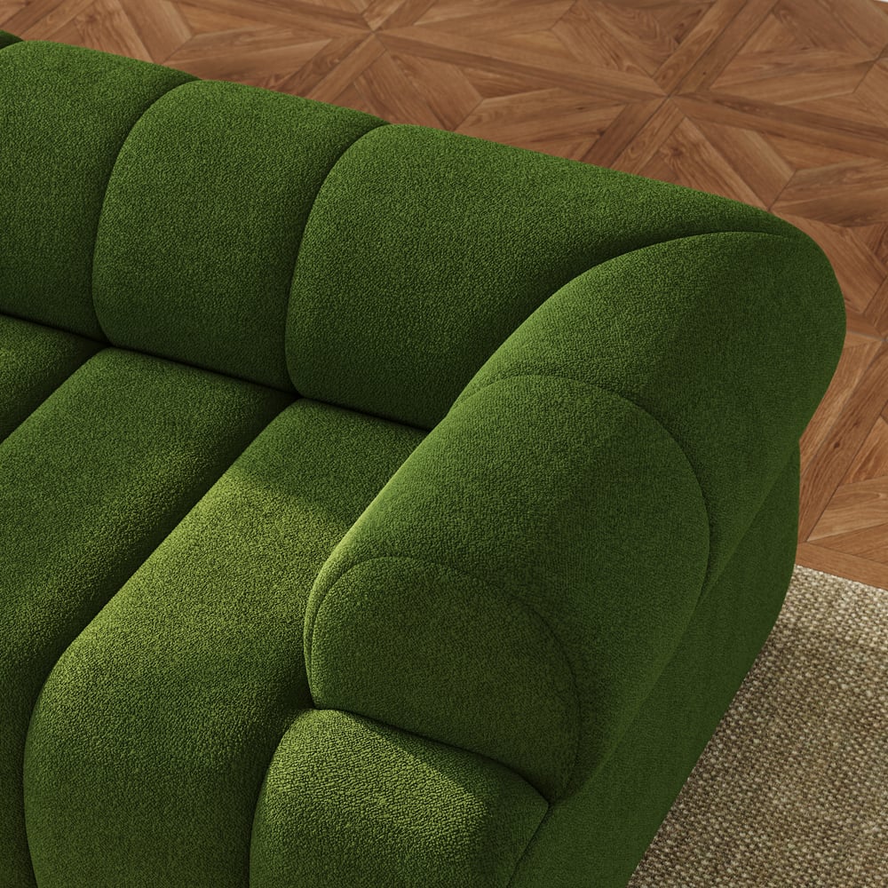 Green sofa on a wooden floor