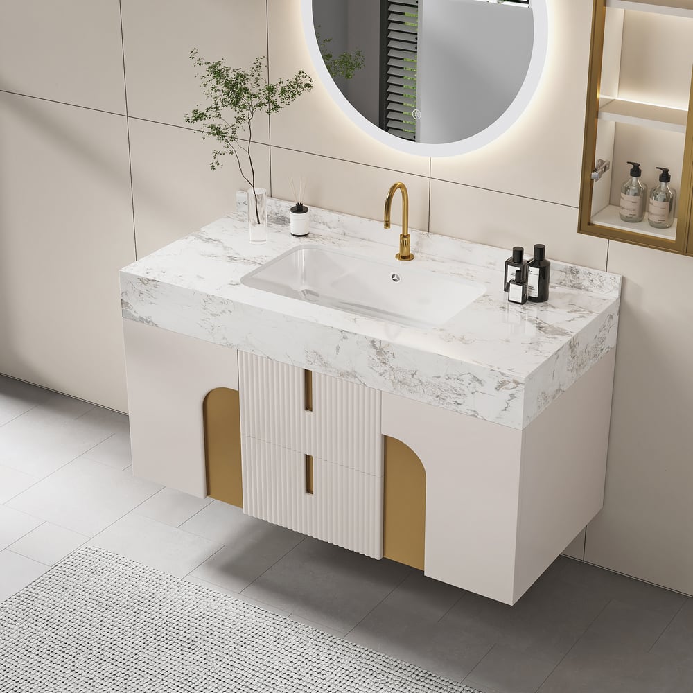 Bathroom vanity with marble countertop and gold fixtures in a modern bathroom setting.