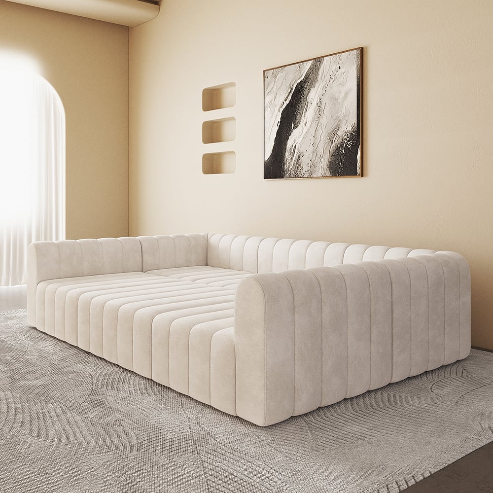 Off white tufted sofa in a room with abstract art on the wall.