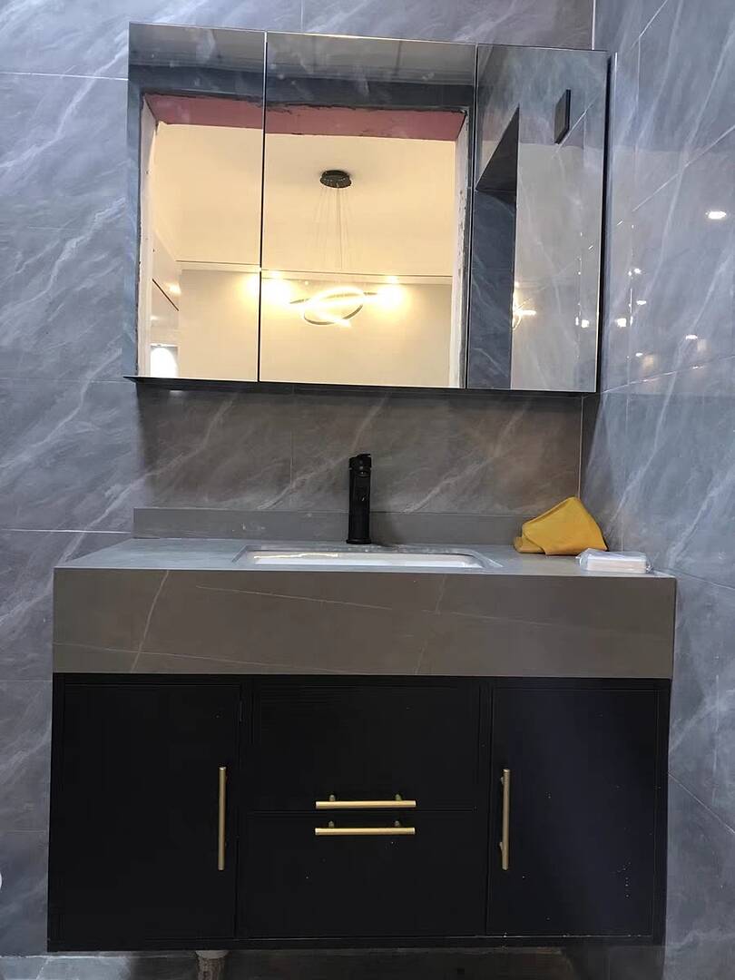 Bathroom vanity with mirror and sink against a gray marble wall