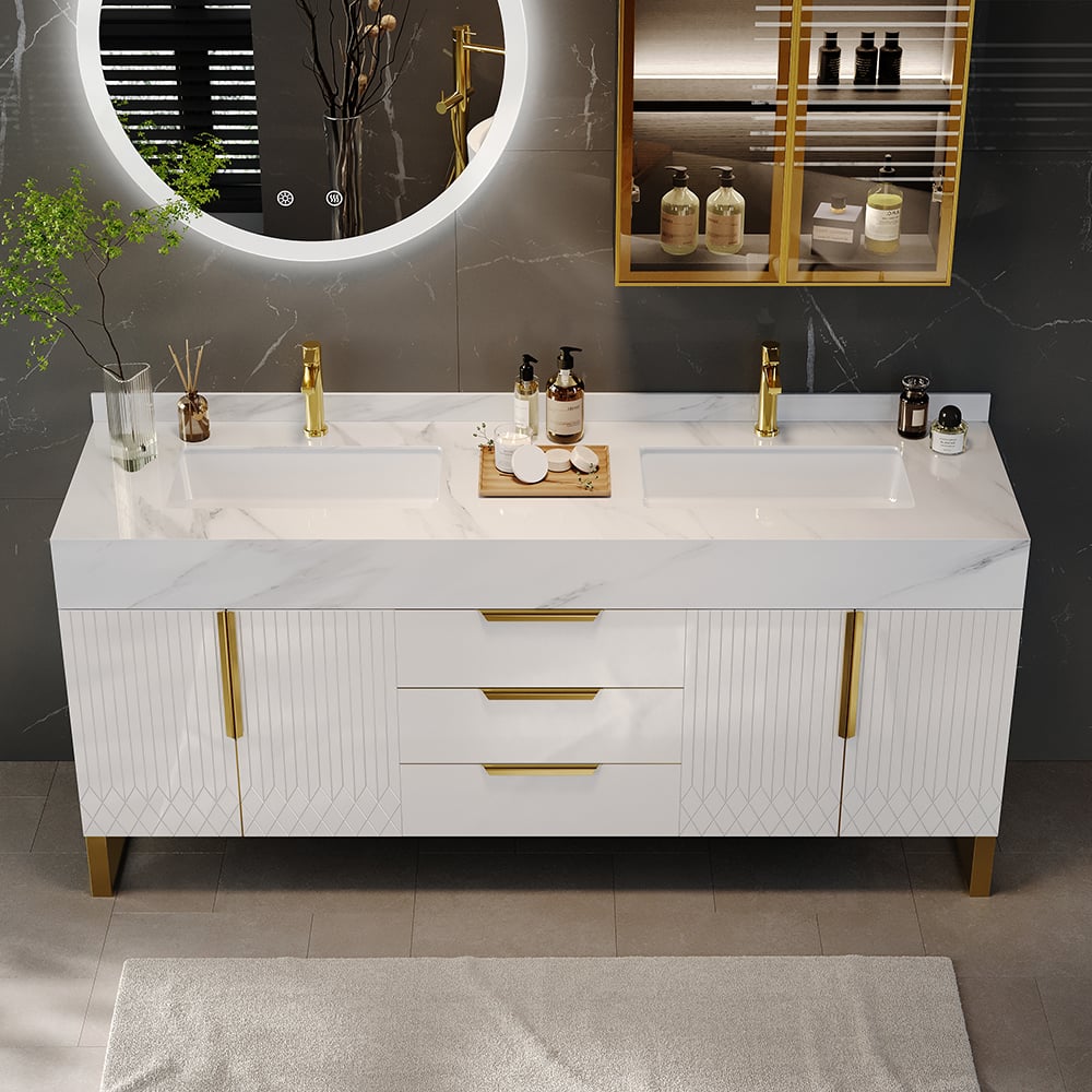 Bathroom vanity with marble countertop, gold fixtures, and decorative items.