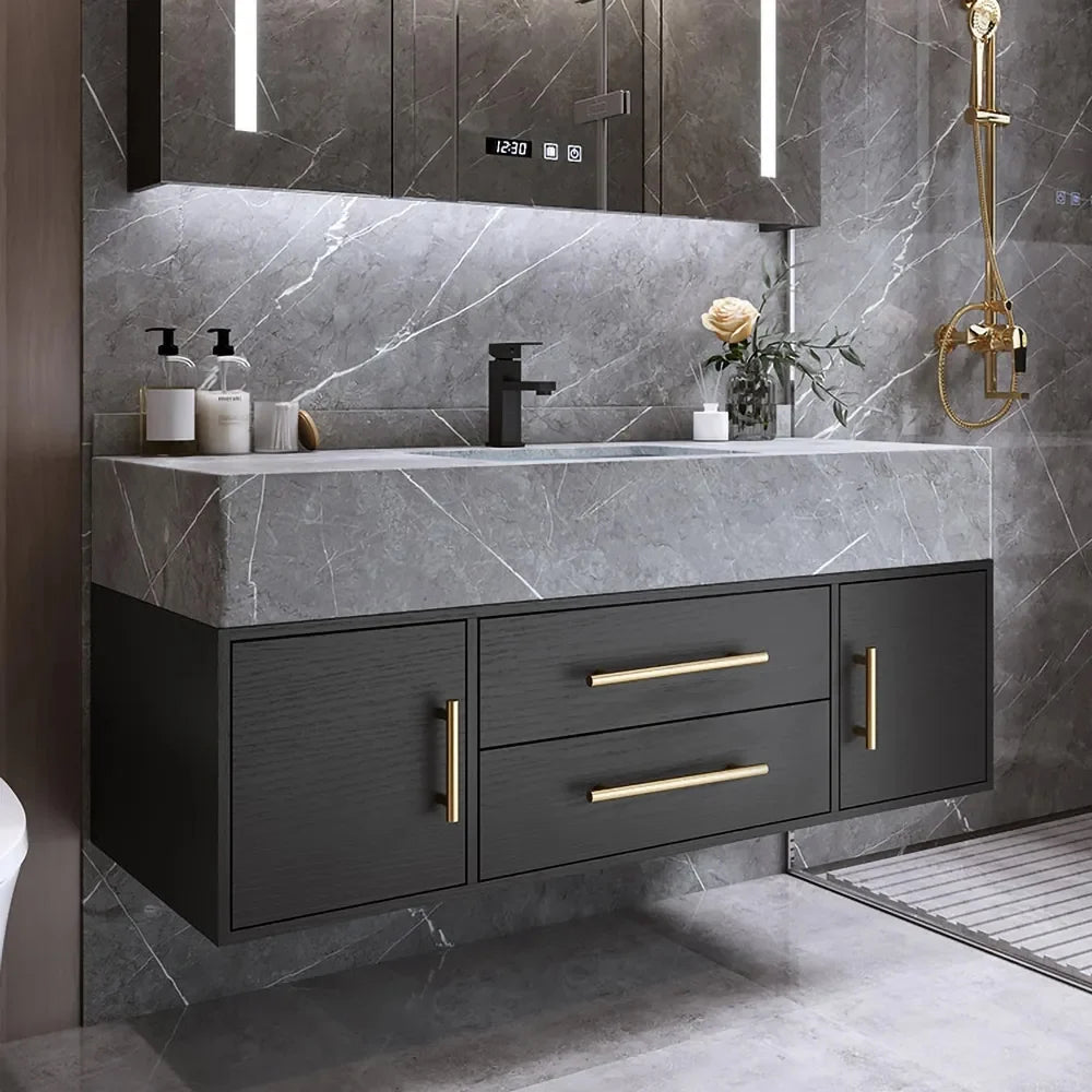 Bathroom vanity with dark cabinets, gold handles, and a marble countertop.