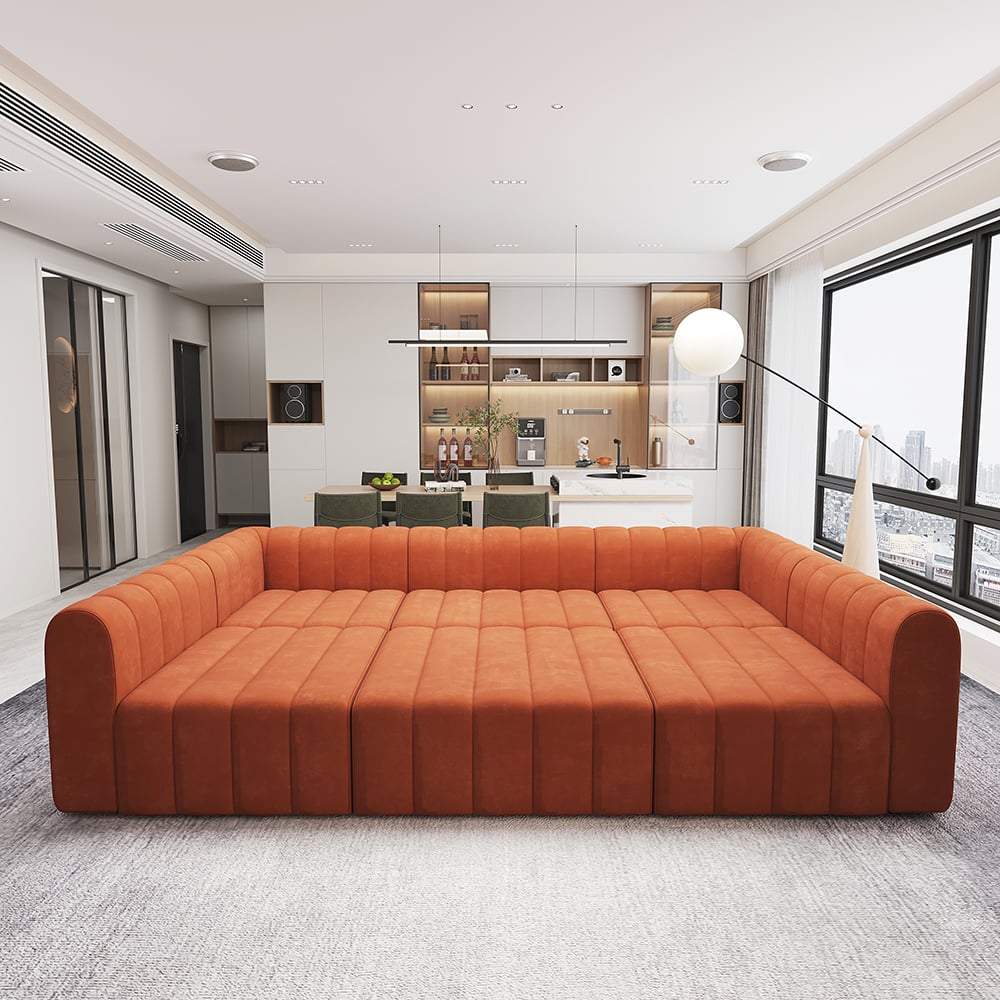 Orange sofa in a modern living room with a kitchen in the background