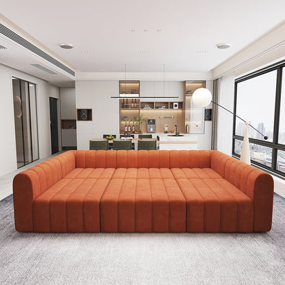 Orange sofa in a modern living room with a kitchen in the background