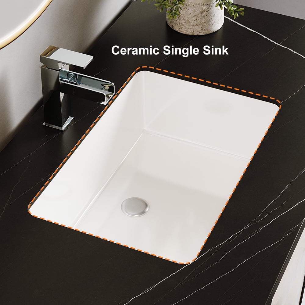 White ceramic single sink with a silver faucet on a black marble countertop.