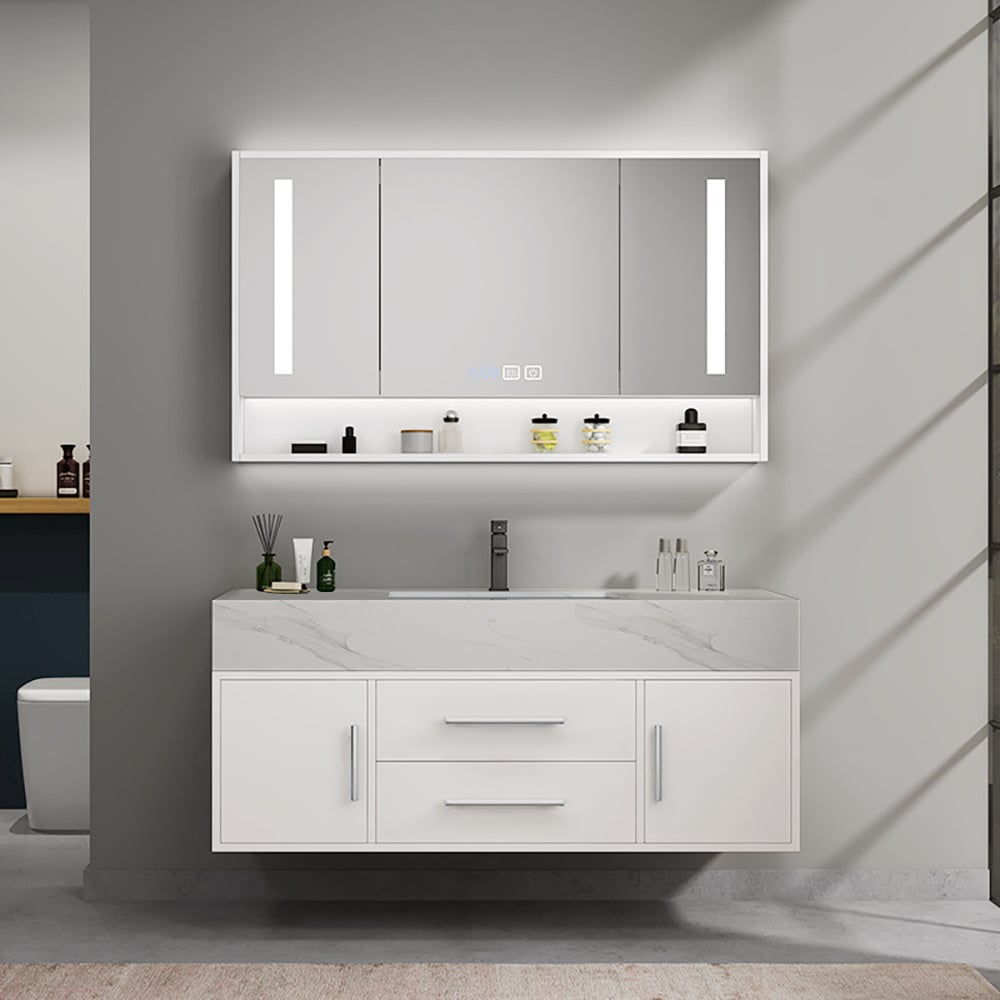 Bathroom vanity with illuminated mirror and various toiletries on a gray wall.