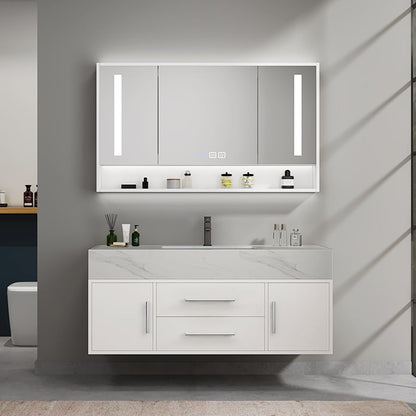 Bathroom vanity with illuminated mirror and various toiletries on a gray wall.