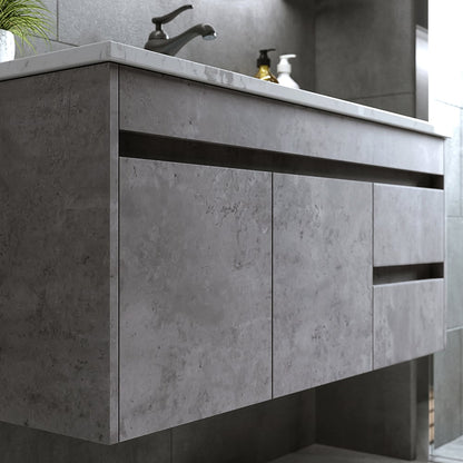 Bathroom vanity with concrete-like finish and faucet in a modern bathroom setting.