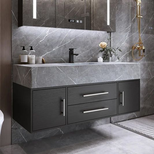 Bathroom vanity with dark cabinets, gray marble countertop, and decorative elements.