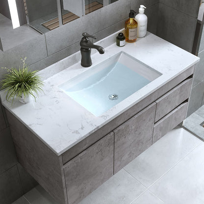 Bathroom vanity with sink, faucet, and toiletries on a light gray countertop.
