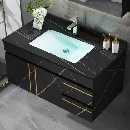 Bathroom vanity with black marble finish, white sink, and decorative items.