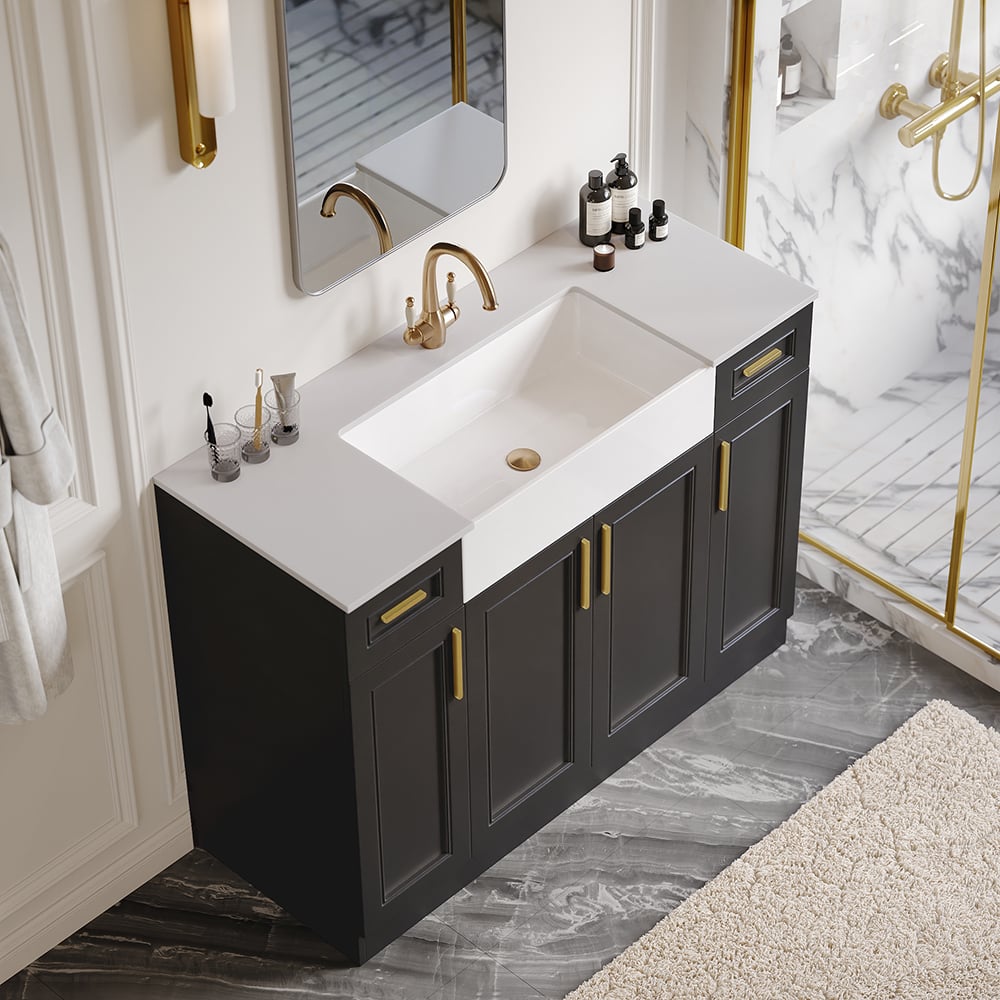 Bathroom vanity with white countertop, sink, and gold fixtures.