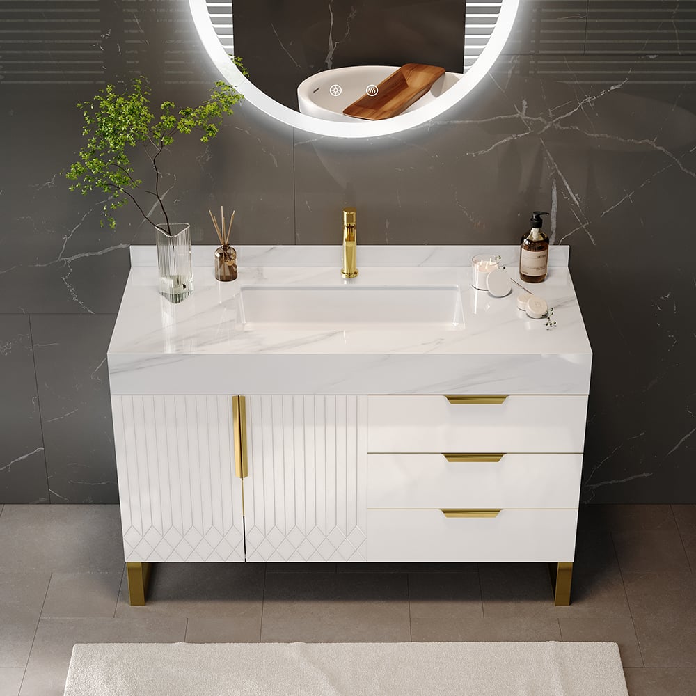 Bathroom vanity with white countertop, gold fixtures, and decorative items against a gray wall.