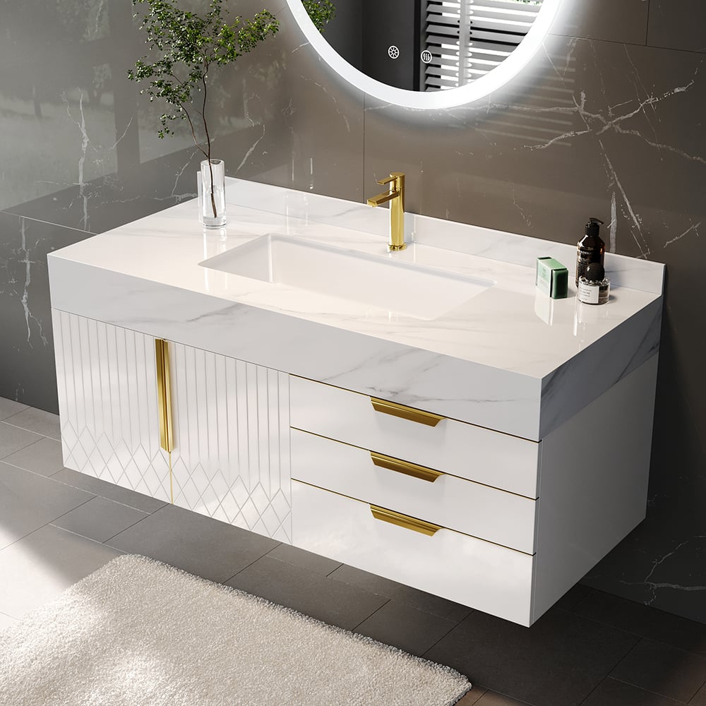 Bathroom vanity with white countertop, gold fixtures, and a round mirror.