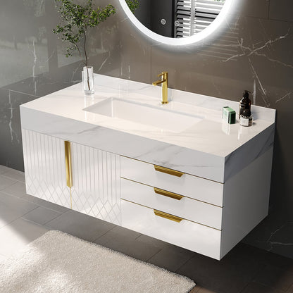 Bathroom vanity with white countertop, gold fixtures, and a round mirror.