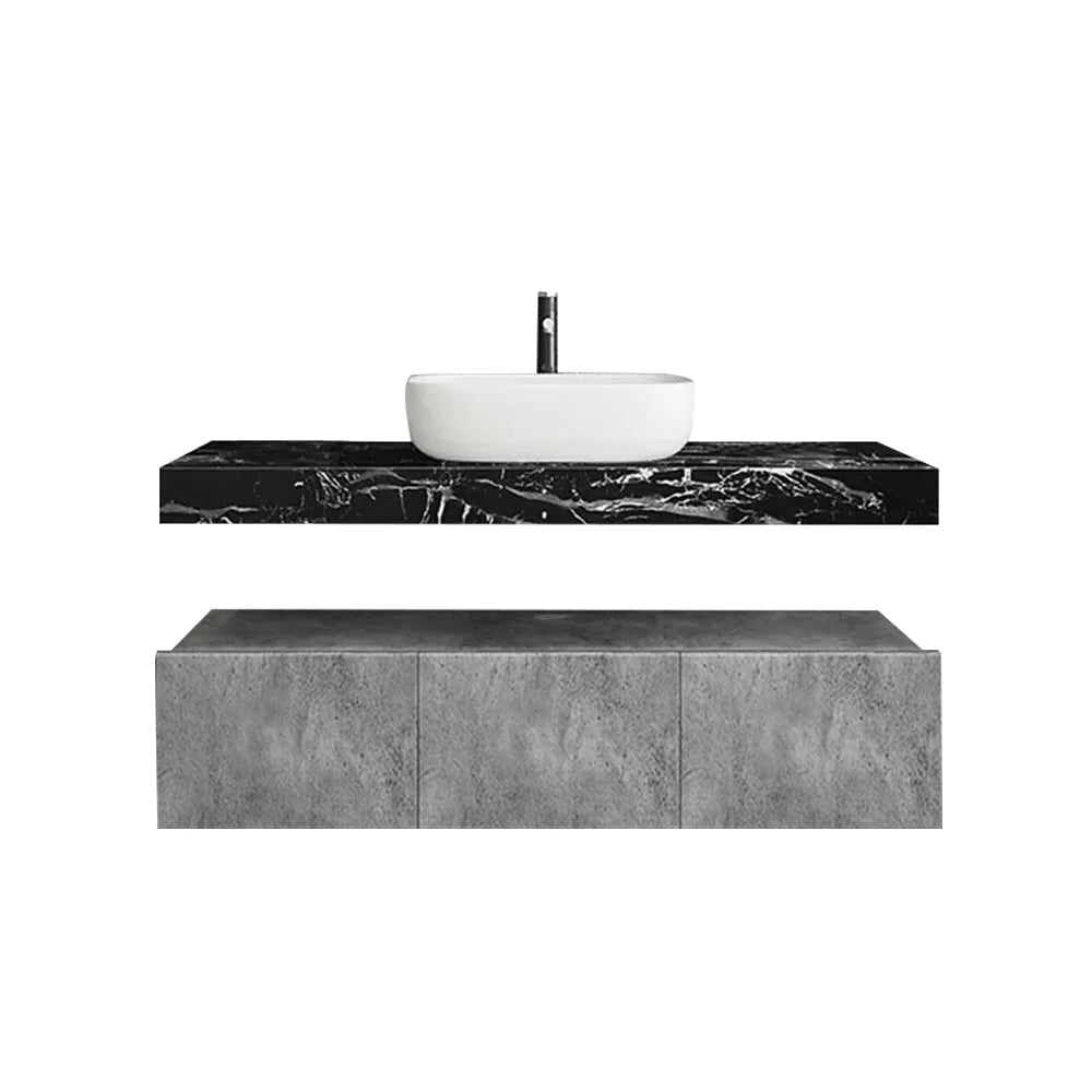 Bathroom vanity with black marble countertop and white sink on a white background