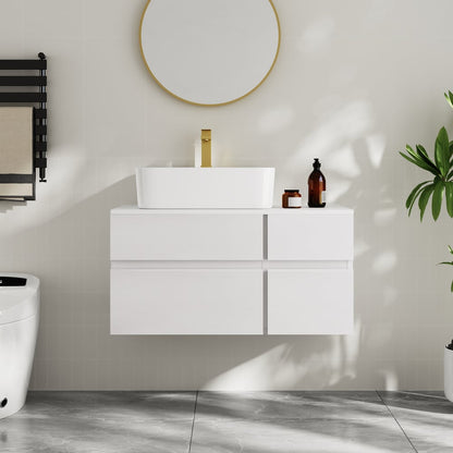 Bathroom setup with a white vanity unit, sink, and decorative items on a light gray wall.
