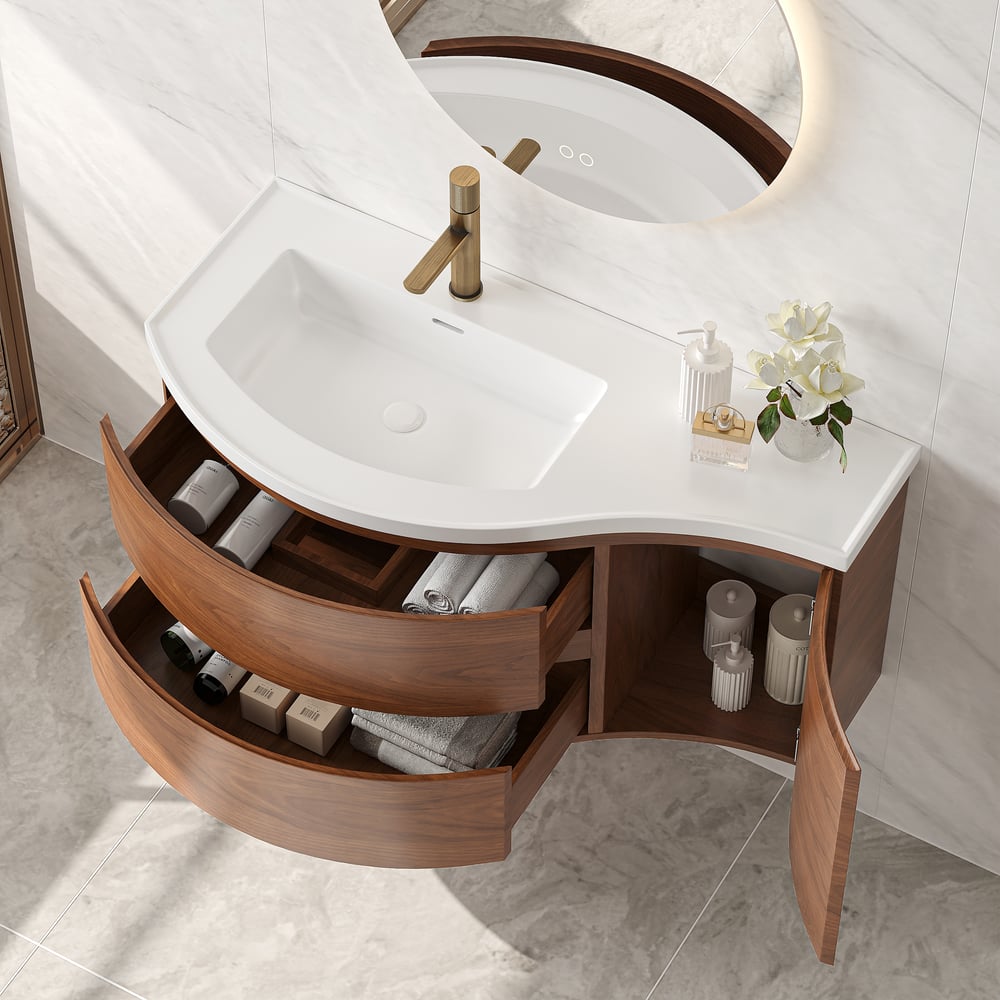 Bathroom vanity with white sink, wooden drawers, and decorative items.