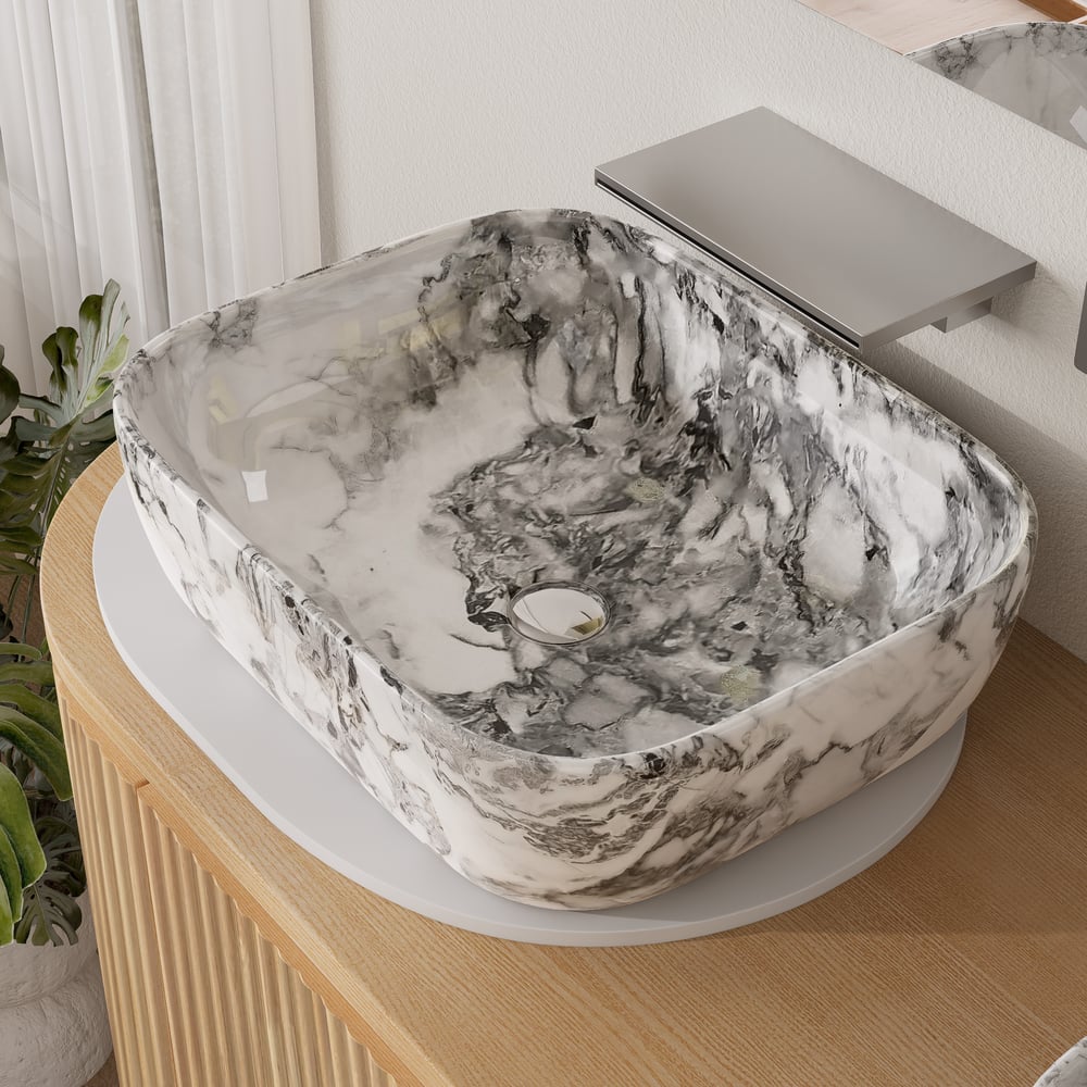 Marble-patterned sink on a wooden cabinet with a blurred background