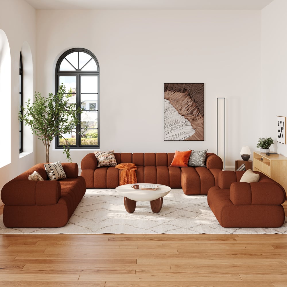 Modern living room with brown sectional sofa, white coffee table, and decorative elements.
