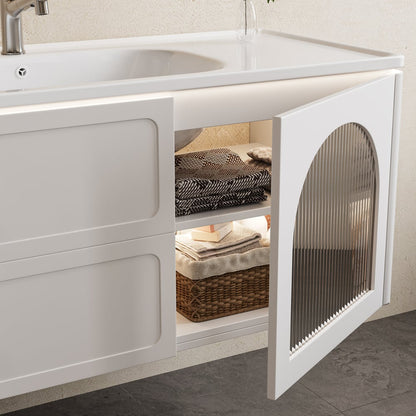 White kitchen cabinet with open door revealing storage items, including a sink.