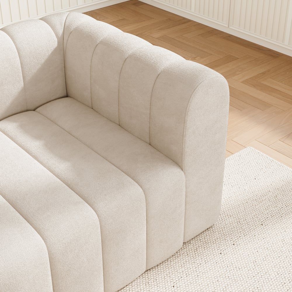 Off white sofa in a room with wooden flooring