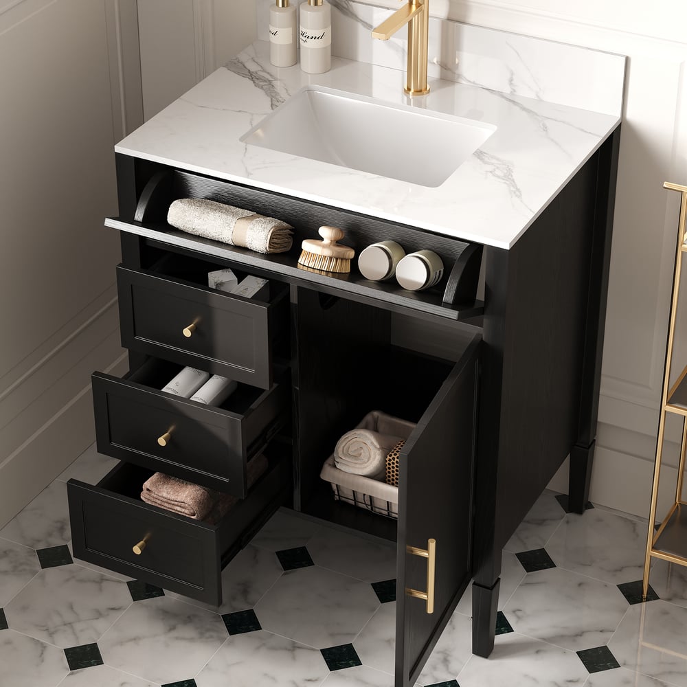 Bathroom vanity with marble countertop, sink, and open drawers with toiletries.