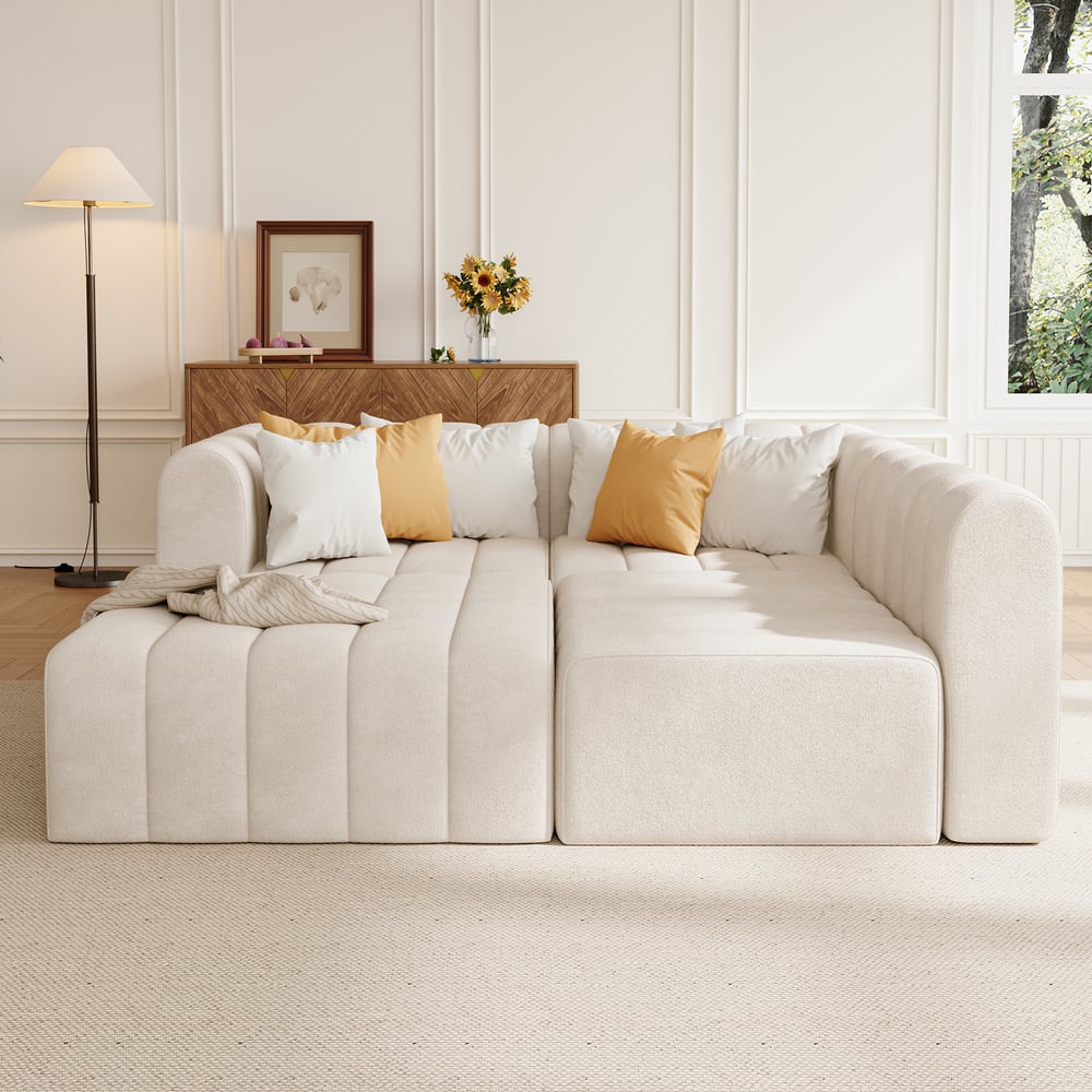 Off white sofa with decorative pillows in a living room setting