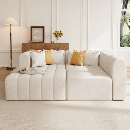 Off white sofa with decorative pillows in a living room setting