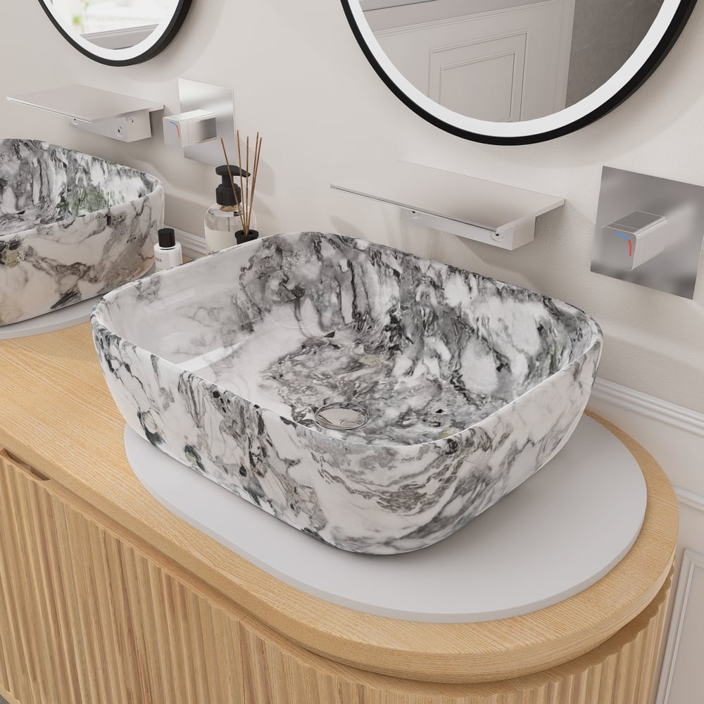 Marble-patterned sink on a wooden vanity with mirrors above