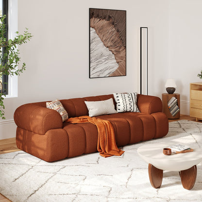 Brown sofa in a living room with a coffee table and decorative items.