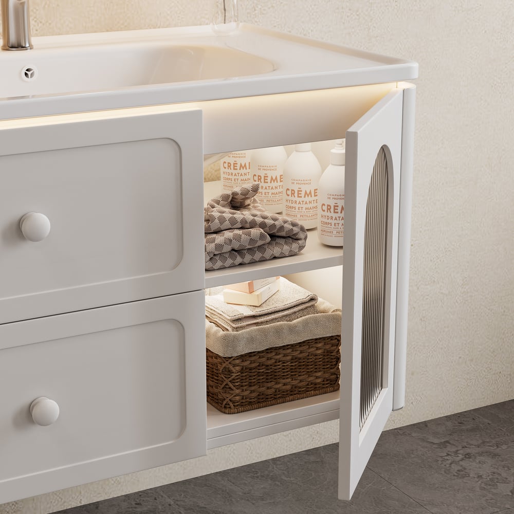 Bathroom vanity with open cabinet revealing towels and a basket