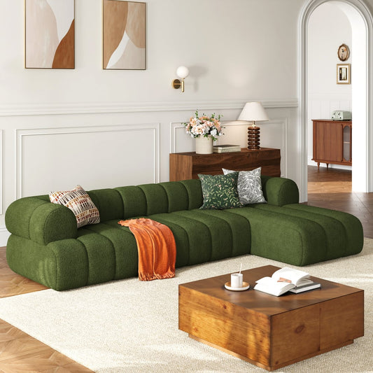 Modern living room with a green sectional sofa and wooden coffee table.