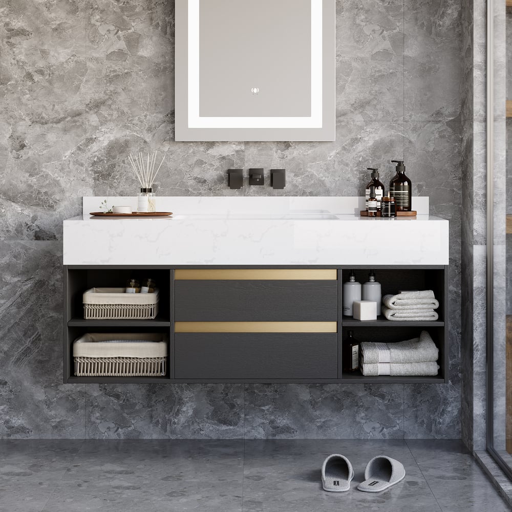 Bathroom vanity with white countertop and black cabinets against a gray stone wall.