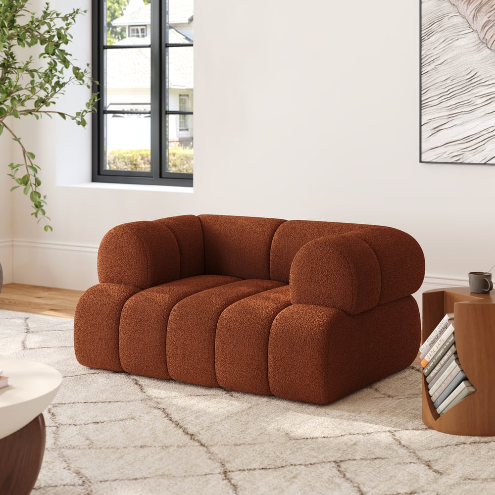 Brown sofa in a modern living room with a plant and coffee table.