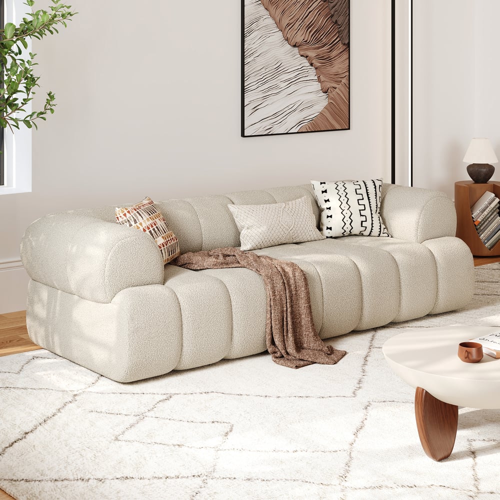 Beige sectional sofa in a living room with decorative pillows and a coffee table.