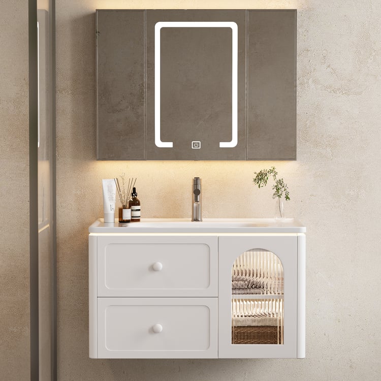 Bathroom vanity with illuminated mirror and decorative items on a neutral wall.