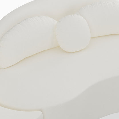 Close-up of a white crib bumper with pom-poms on a white background