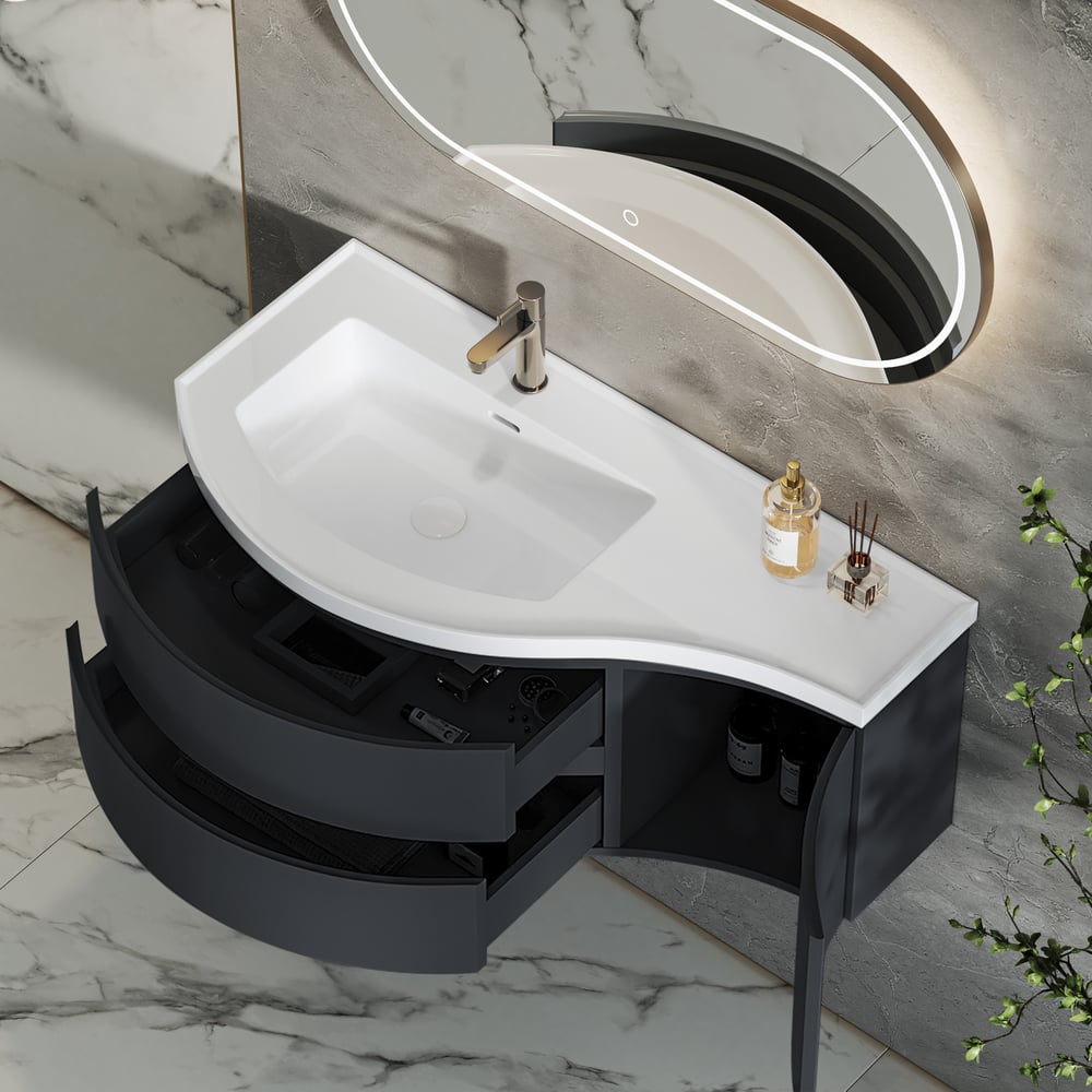 Bathroom vanity with white sink and black cabinet against a marble wall.