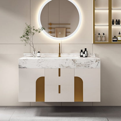Bathroom vanity with marble countertop, round mirror, and gold accents.