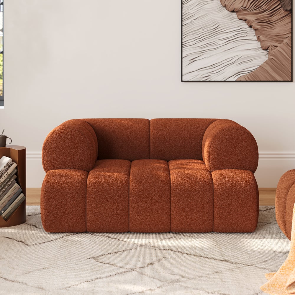Brown sofa in a living room setting with a abstract painting on the wall.